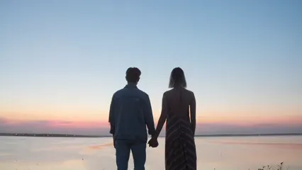 Horizontal video: Couple holding hands watching sunset 5107299. Duration: 15 seconds. Resolution: 3840x2160