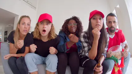 Horizontal video: Group cheering on the couch 6104275. Duration: 22 seconds. Resolution: 3840x2160