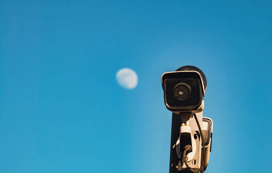 CCTV Camera against Blue Sky with Full Moon