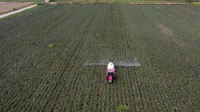 Horizontal video: Aerial view of tractor spraying farm field 28867432. Duration: 13 seconds. Resolution: 3840x2160
