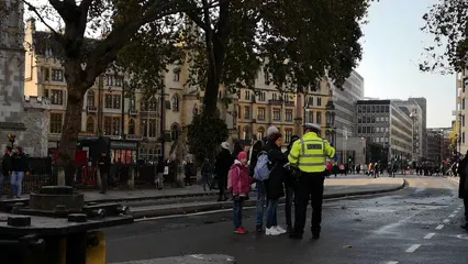 Horizontal video: A family of tourist is asking direction from a police officer in london street 3206823. Duration: 12 seconds. Resolution: 3840x2160