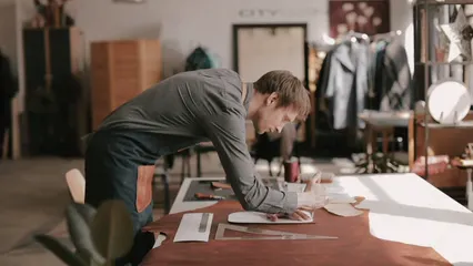 Horizontal video: A man tracing a template onto the leather 4452786. Duration: 10 seconds. Resolution: 1920x1080