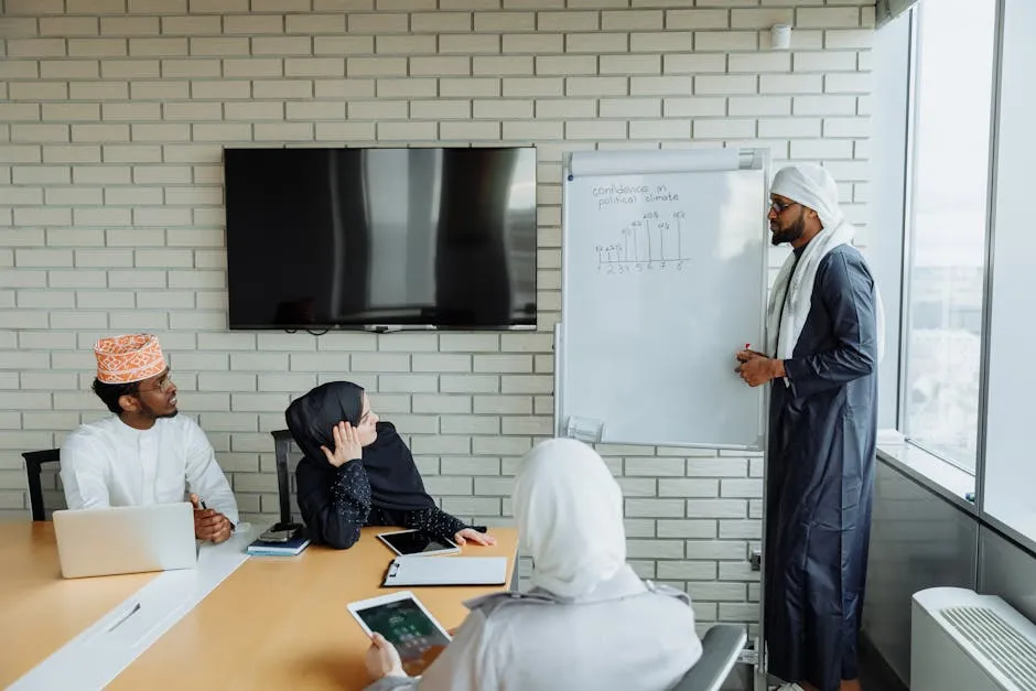 Office Workers Having a Meeting with a Man Standing beside a Whiteboard 