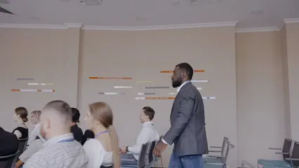 Horizontal video: Man arriving at a business presentation 8716428. Duration: 11 seconds. Resolution: 3840x2160