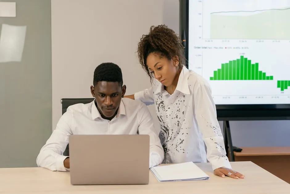 A Man and a Woman Looking at a Laptop