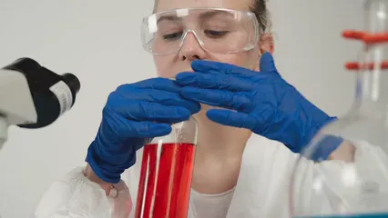 Horizontal video: A scientist smelling colored liquid in a glass bottle 9430530. Duration: 14 seconds. Resolution: 1920x1080