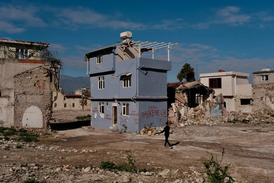 Man Walking Among the Destroyed Houses