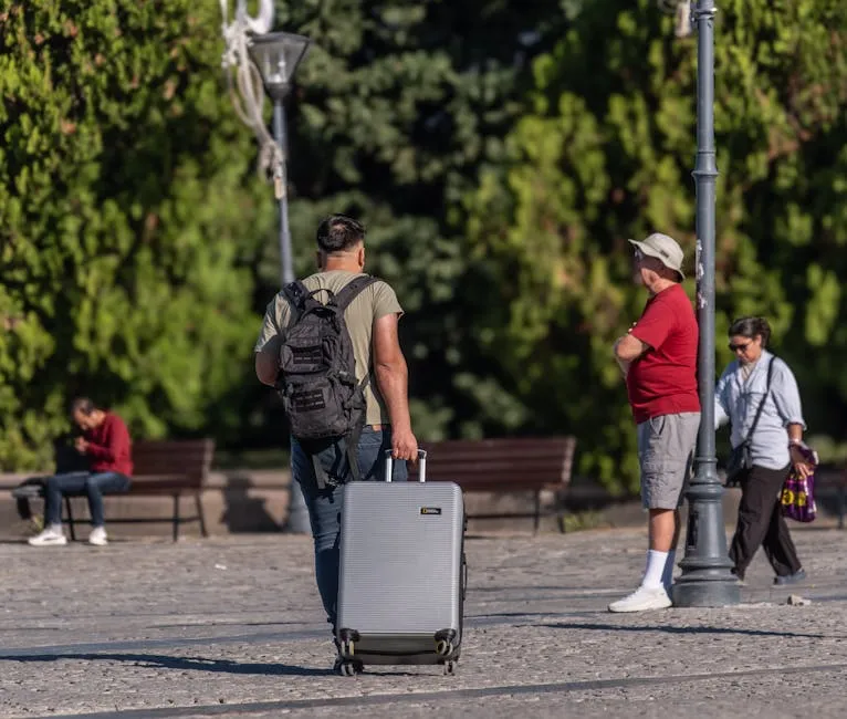 Traveler with suitcase in a sunny park setting