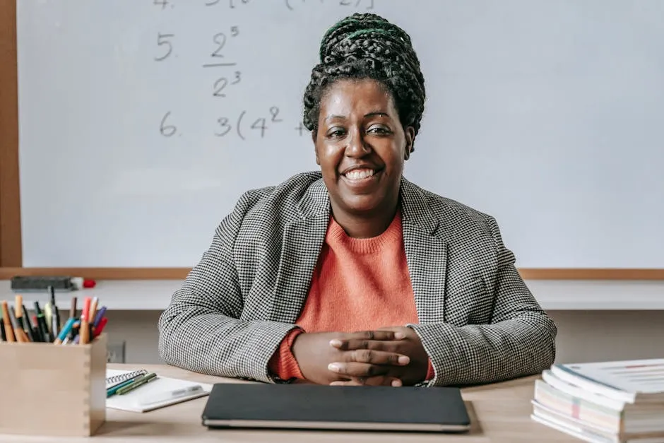 Black cheerful woman smiling and sitting at table