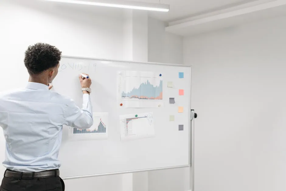 A Man in Long Sleeve Shirt Writing on White Board