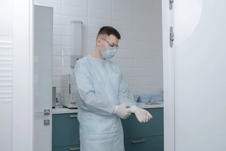 Man in Blue Scrub Suit Standing in the Laboratory