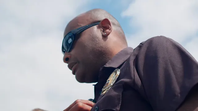 Horizontal video: Low angle shot of male police officers talking to each other 7713975. Duration: 19 seconds. Resolution: 3840x2160
