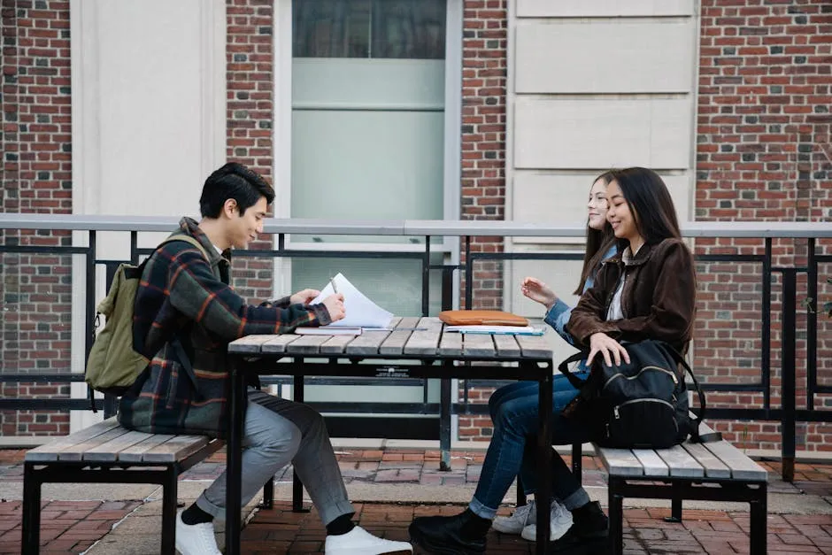 Group of Students Sitting on a Wooden Bench