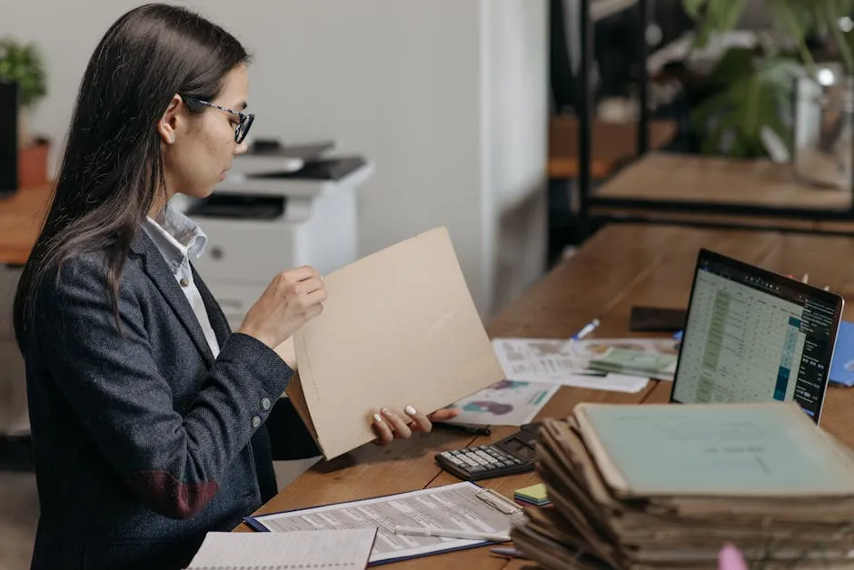 Woman Holding a Brown Folder while Working in the Office