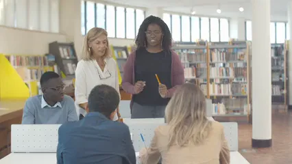Horizontal video: Teacher and students in a library 5940174. Duration: 17 seconds. Resolution: 3840x2160
