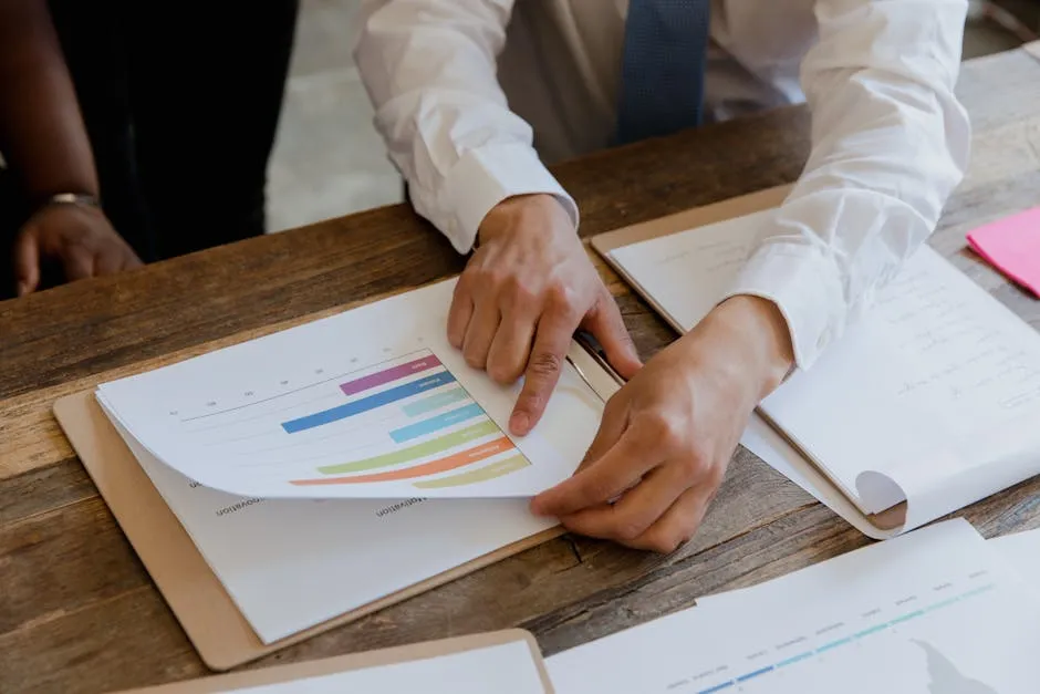 Documents on Desk, Man Pointing on Data