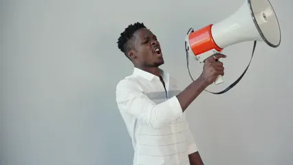 Horizontal video: A man is holding a megaphone and shouting 8847598. Duration: 22 seconds. Resolution: 1920x1080