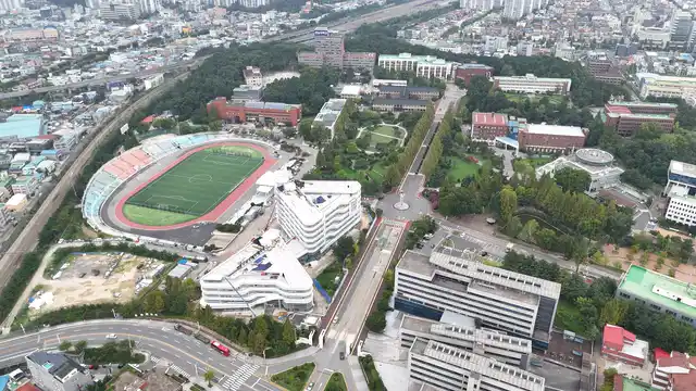 Horizontal video: Aerial view of university campus and stadium 28844382. Duration: 24 seconds. Resolution: 3840x2160