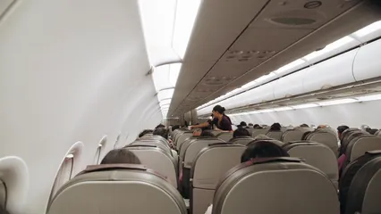 Horizontal video: Flight attendants assisting passengers inside a plane 3701068. Duration: 8 seconds. Resolution: 1920x1080