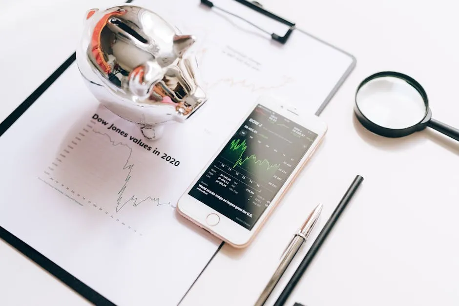 Smartphone Displaying a Stock Market Chart and Lying on a Document next to a Magnifying Glass