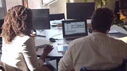 Horizontal video: Group discussing charts in front of a computer 6248600. Duration: 9 seconds. Resolution: 3840x2160