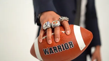 Horizontal video: A man holding a football with rings on his fingers 7006036. Duration: 9 seconds. Resolution: 1920x1080