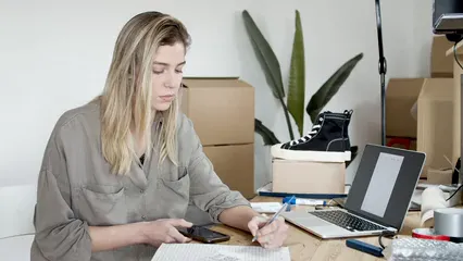 Horizontal video: Woman answering phone call and writing 7287526. Duration: 13 seconds. Resolution: 3840x2160