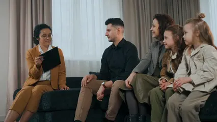 Horizontal video: A family sitting in the sofa with the realtor 7646358. Duration: 10 seconds. Resolution: 3840x2160