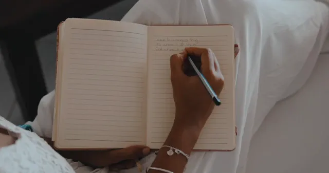Horizontal video: Close up of woman writing in notebook 11025392. Duration: 23 seconds. Resolution: 4096x2160