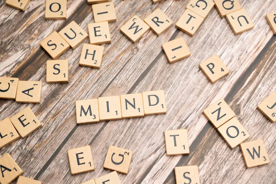 Scrabble letters spelling the word mind on a wooden table