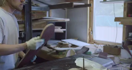 Horizontal video: A craftsman shaping the edges of a skateboard 4888903. Duration: 18 seconds. Resolution: 4096x2160