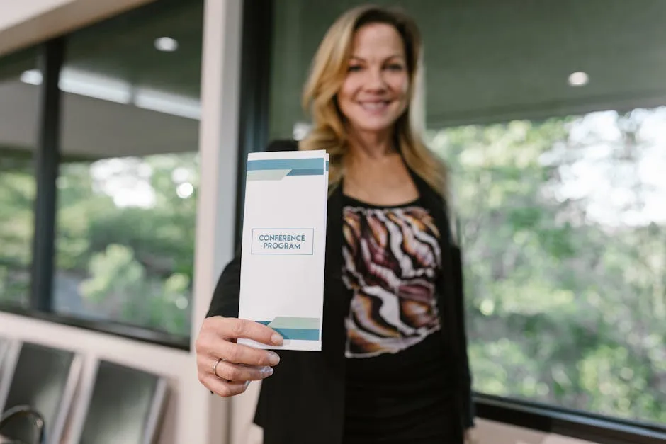 A Woman Holding a Conference Program Pamphlet