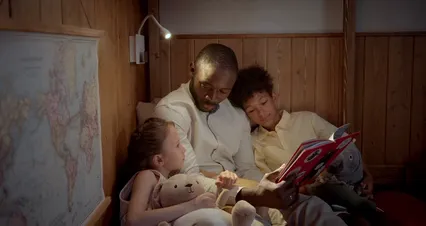 Horizontal video: A father reading a book for his children 9874083. Duration: 55 seconds. Resolution: 4096x2160