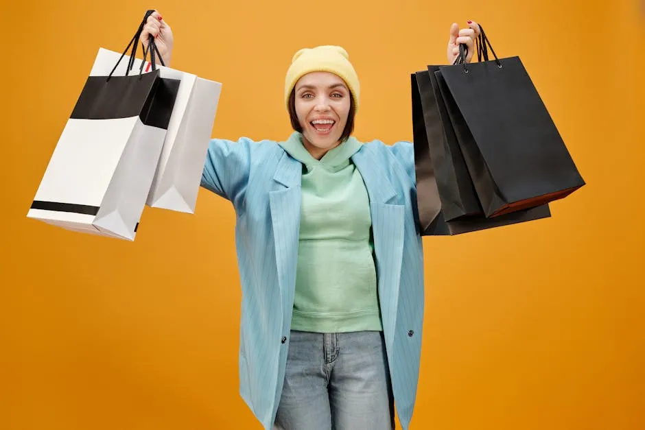 A Happy Woman Holding Paper Bags while Smiling at the Camera