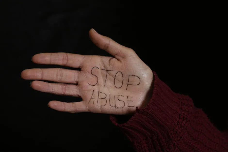 Woman Showing her Palm with Stop Abuse Text Written on it