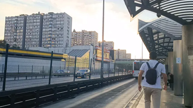Horizontal video: Urban commuters at modern bus station at dusk 28842235. Duration: 20 seconds. Resolution: 3840x2160