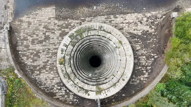 Horizontal video: Aerial view of reservoir spillway spiral 28934195. Duration: 19 seconds. Resolution: 3840x2160
