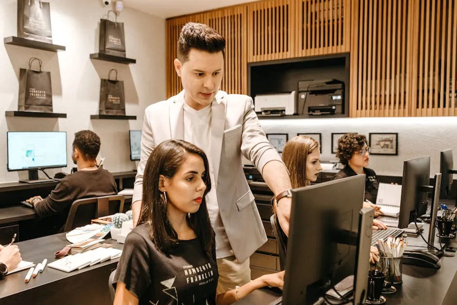 Man Teaching Woman in Front of Monitor