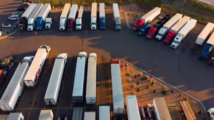 Horizontal video: Drone video of transport trucks at logistic yard 5171156. Duration: 16 seconds. Resolution: 3840x2160
