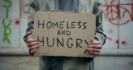 Horizontal video: A homeless person holding a sign 8077343. Duration: 17 seconds. Resolution: 4096x2160