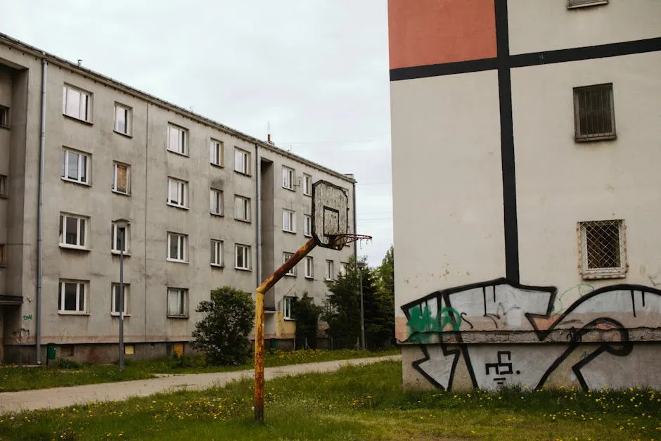 Rusty Basketball Court Near Abandoned Buildings