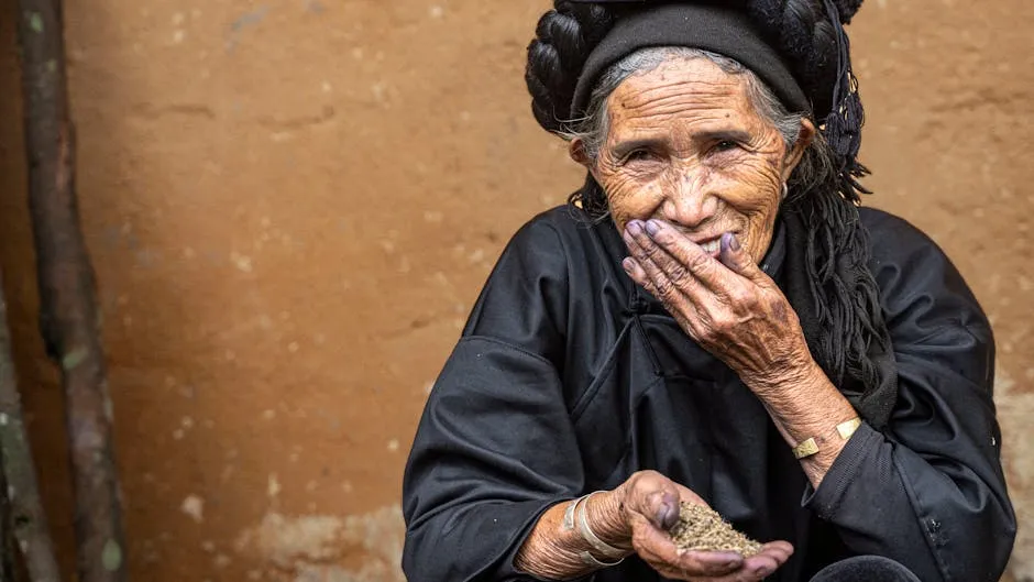 Photo of an Elderly Smiling Woman Holding Grains in Her Hand 