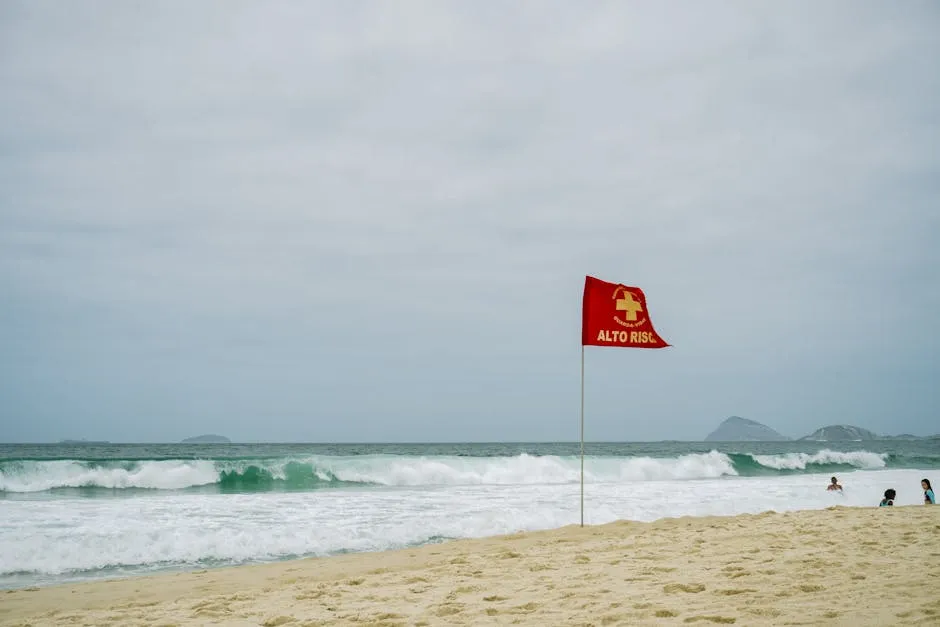 Warning Sign at Sandy Beach with High Waves