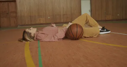 Horizontal video: A person helping a woman in standing up from the floor and getting the ball 6077075. Duration: 8 seconds. Resolution: 4096x2160