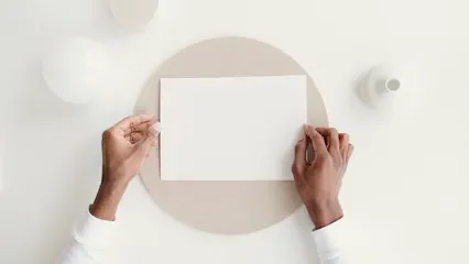 Horizontal video: Person placing blank paper on table 6787189. Duration: 12 seconds. Resolution: 3840x2160