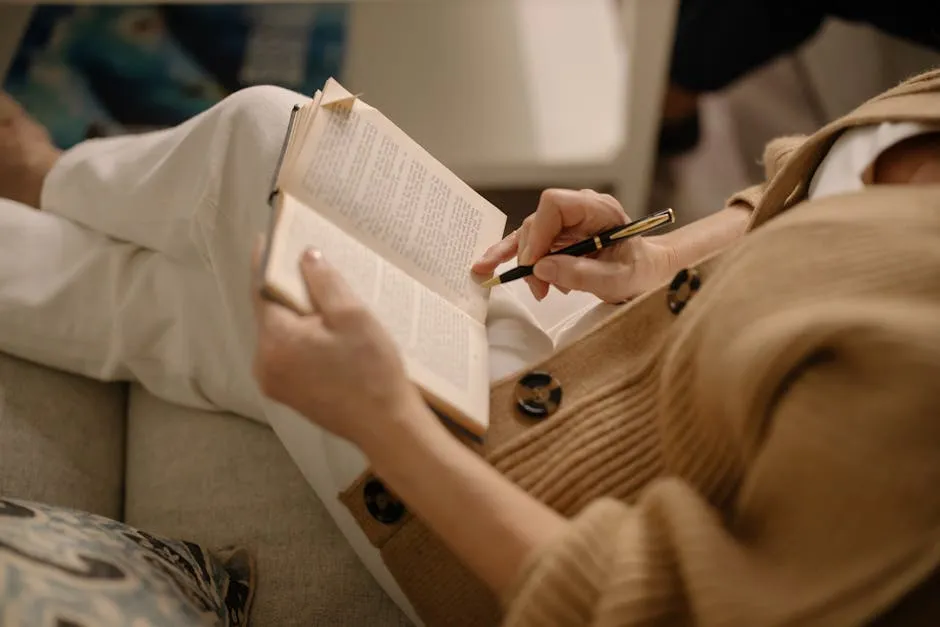 Woman Relaxing on Sofa Reading Book