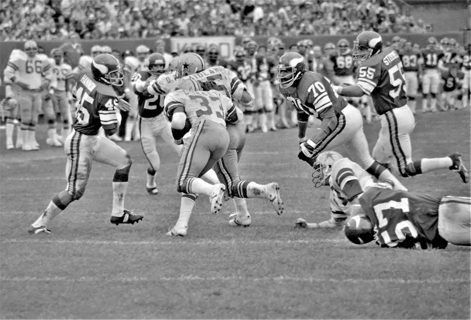 A Grayscale of Football Players on a Field