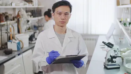 Horizontal video: A man in the laboratory holding a clipboard 4121726. Duration: 11 seconds. Resolution: 3840x2160