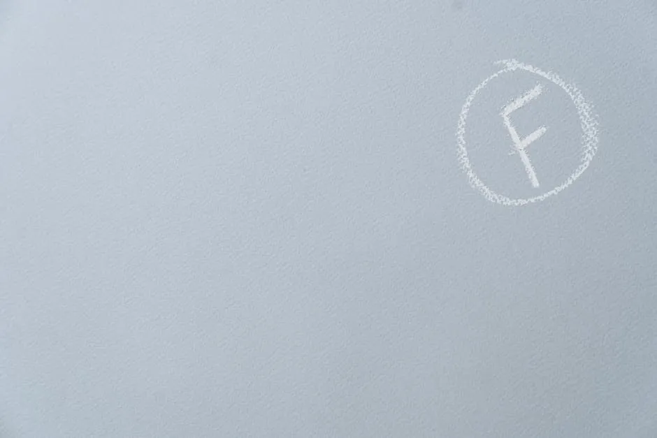 An F Mark in a Circle Drawn with Chalk on Light Blue Surface