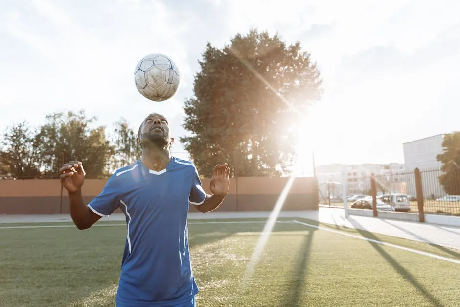 A Footballer Bouncing the Ball on His Head